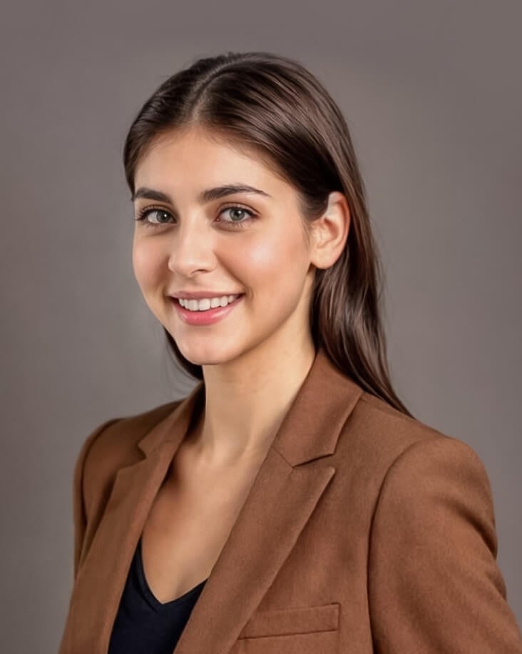 headshot of a female with long hair in the brown business suit standing sideways generated by Fotor online AI LinkedIn photo generator