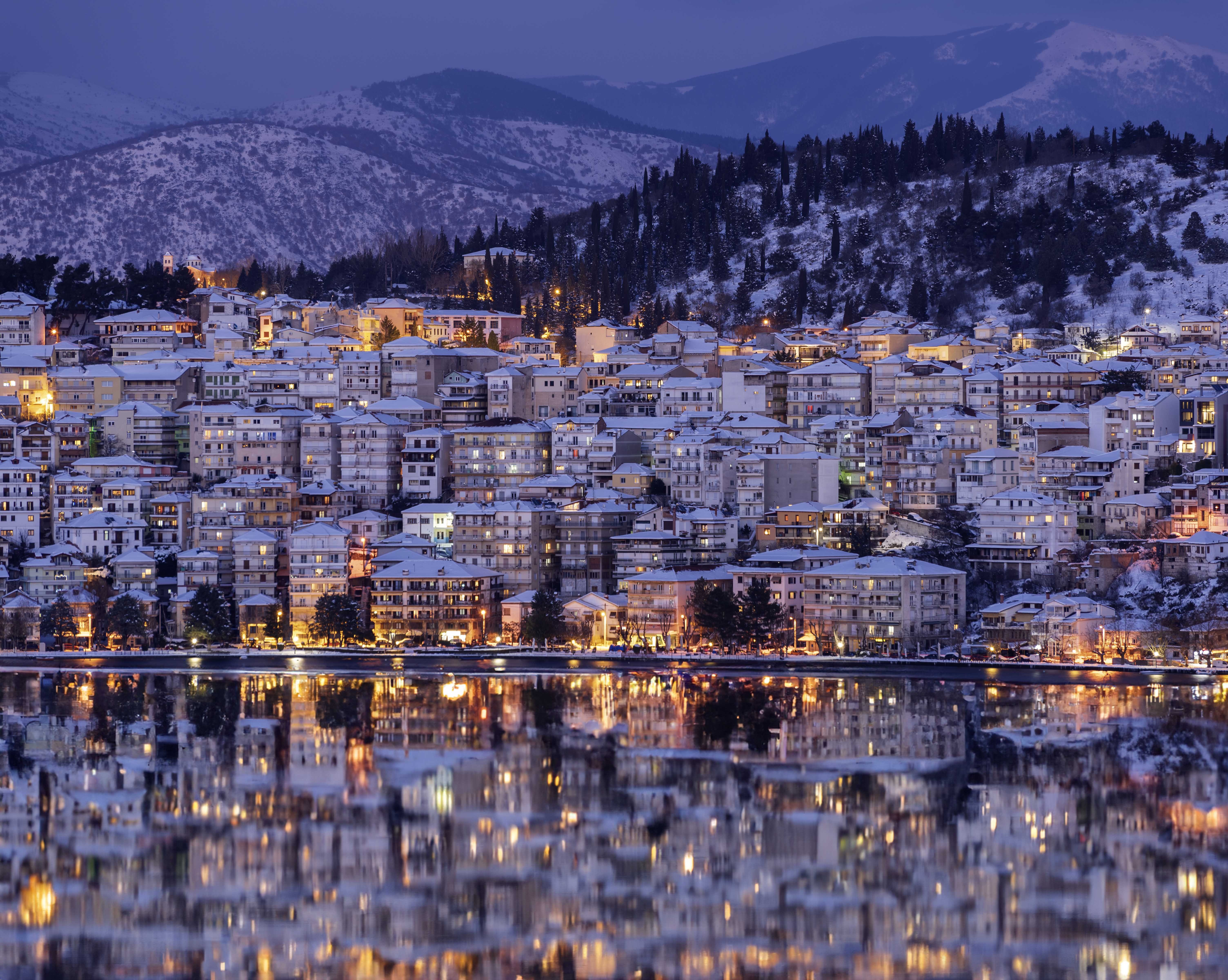 A photograph of a town view in front of a mountain