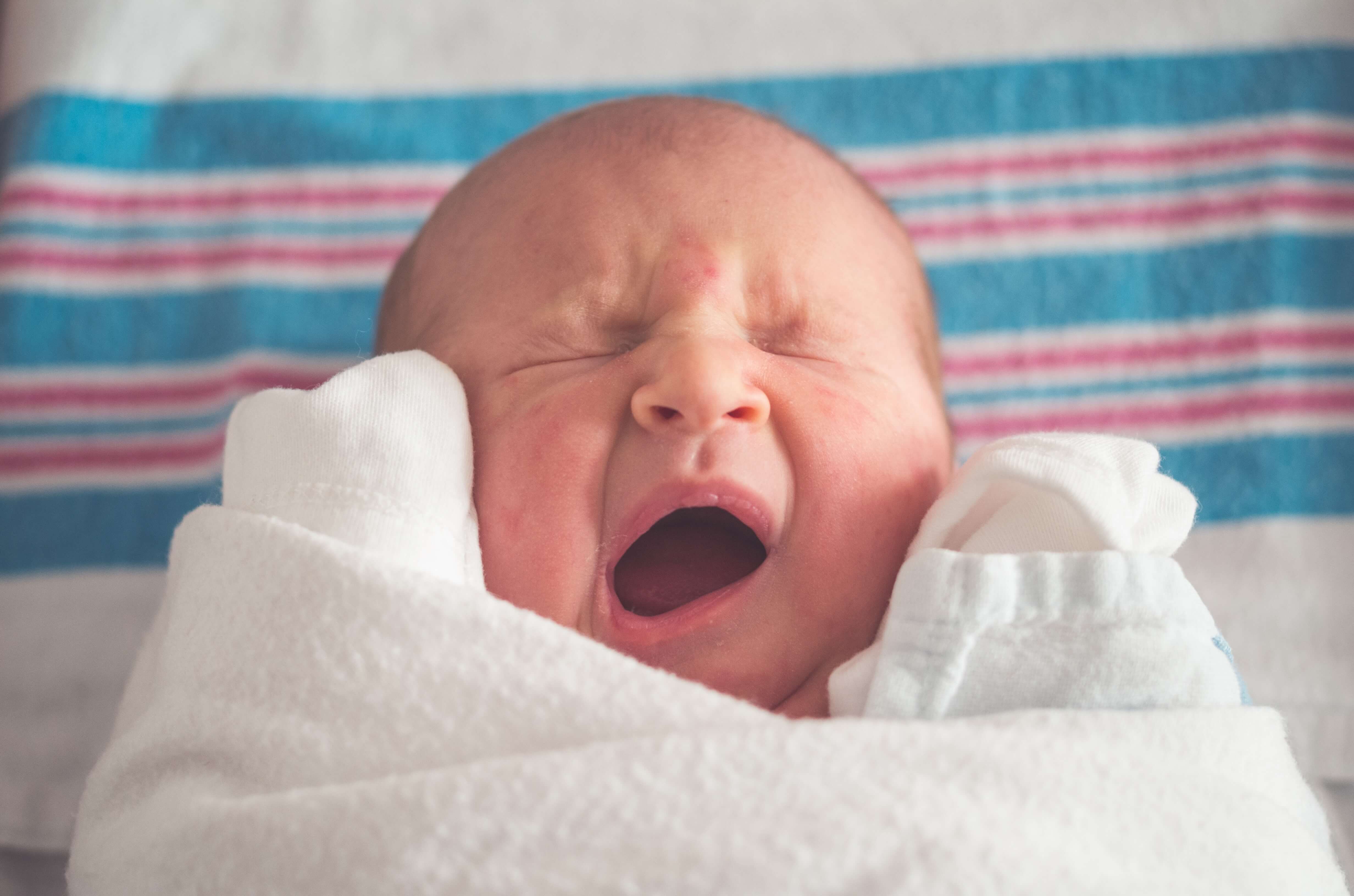 A cute yawning newborn