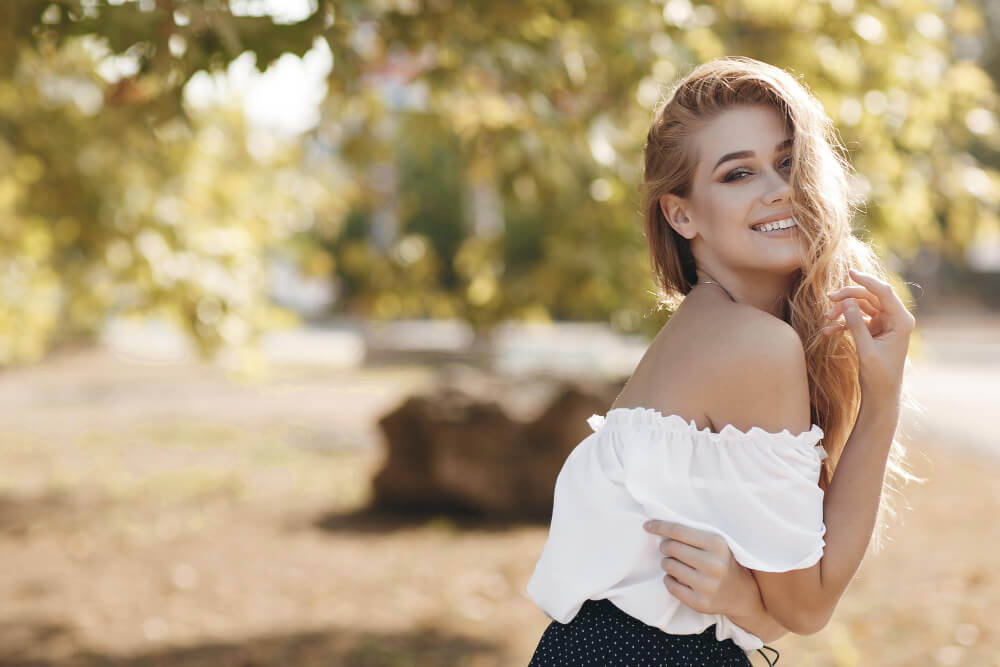 A girl with a sweet smile in the park