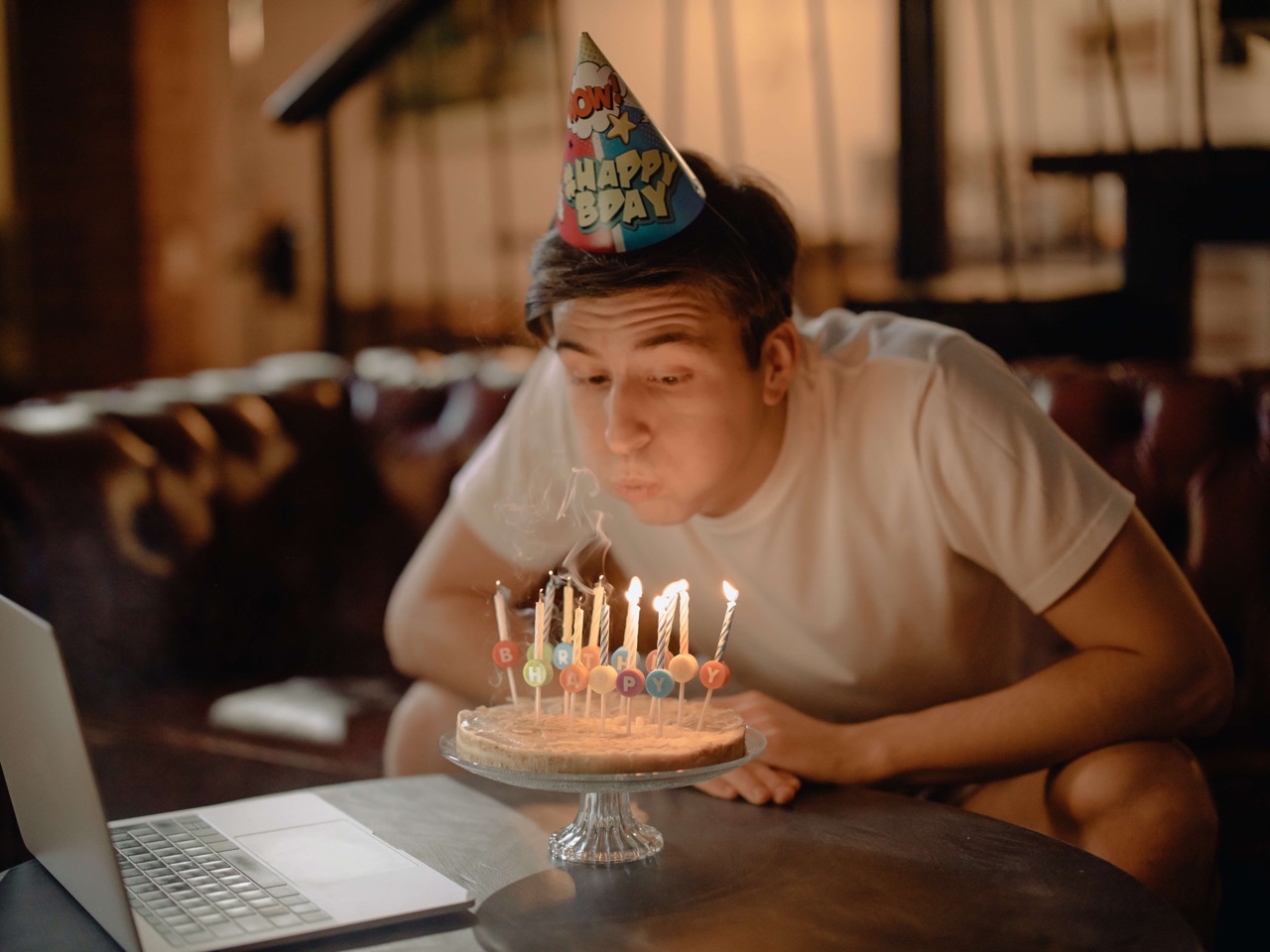 A man blowing out birthday candles