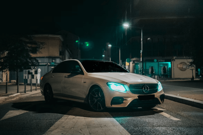 A white benz parking in the middle of the road