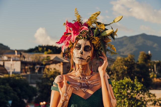 A woman in zombie makeup, flowers in her hair