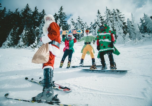 Four friends act as Santa Claus and a Christmas tree