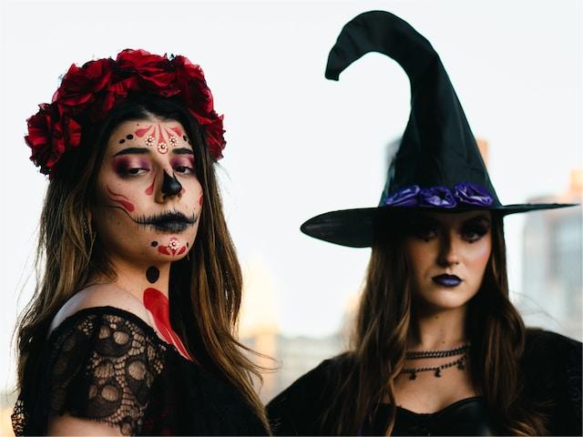 Red witch makeup for one girl, purple witch makeup for the other girl