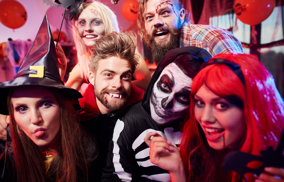 Six friends posing as Halloween characters take a selfie