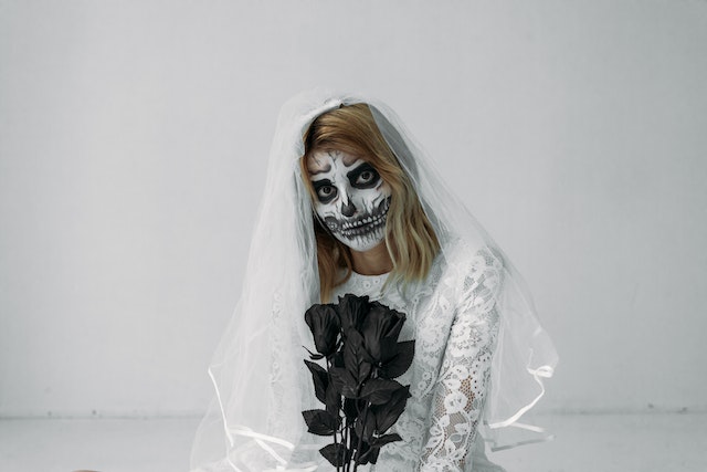 The bride in her wedding dress wore zombie makeup