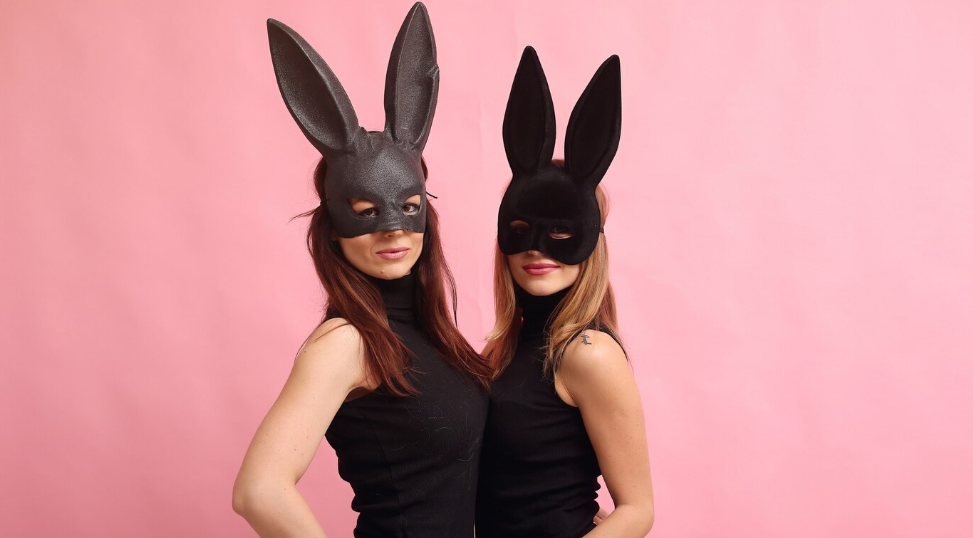 Two girls wearing bunny ear masks