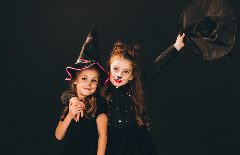Two little girls in witch hats