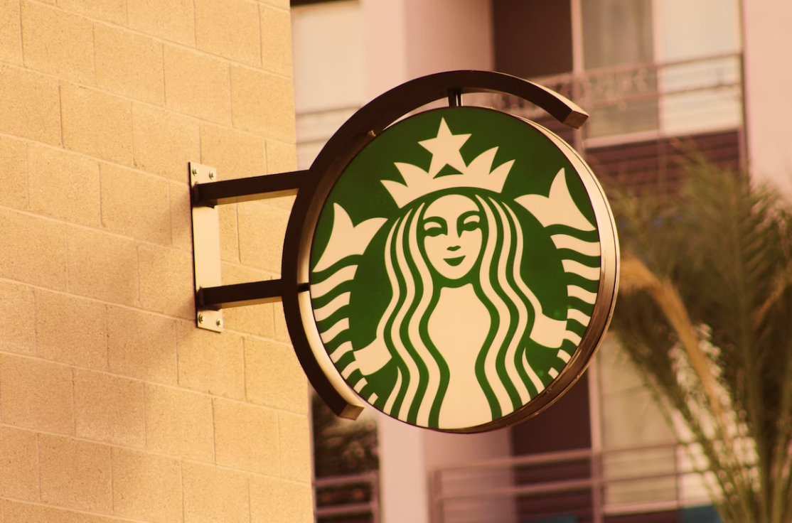 a Starbucks logo on the ad board on the wall