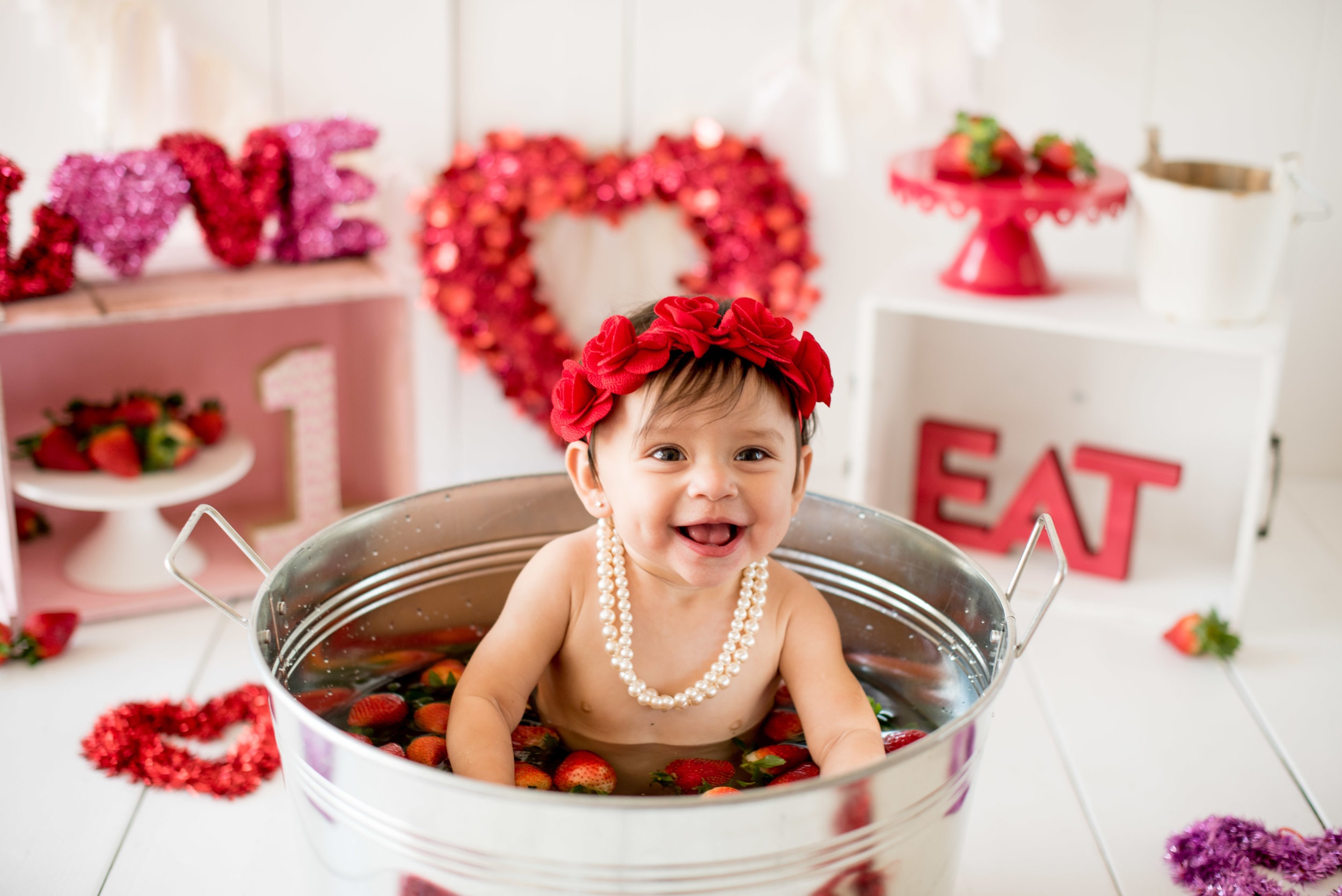 a Valentien photoshoot of a baby wearing rose wreath
