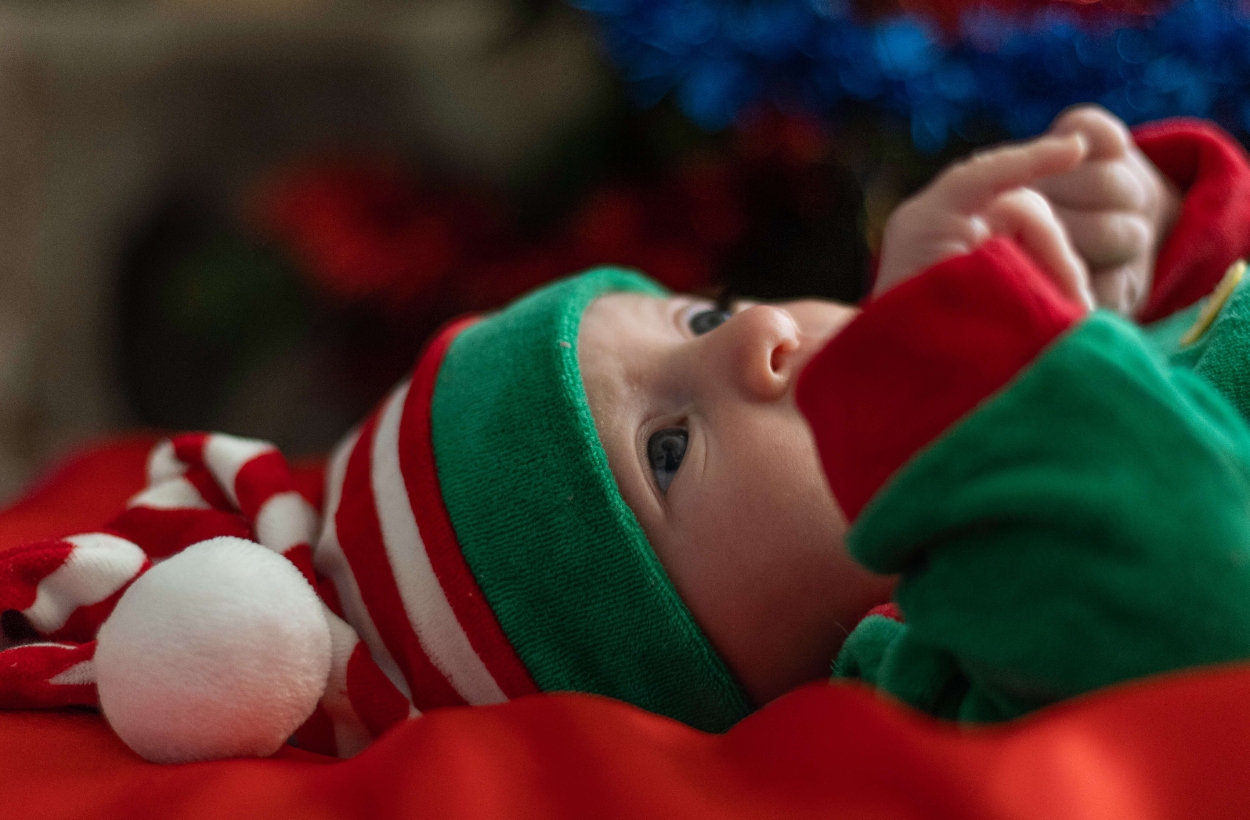 a baby wearing Christmas-themed pajamas