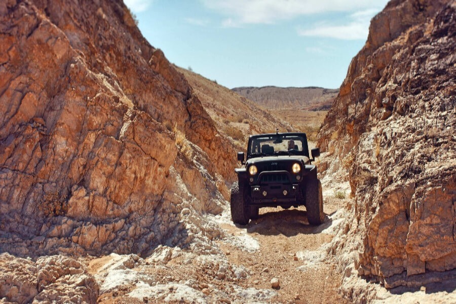 a black car in the rocky road