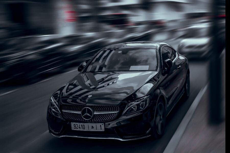 a black car with motion blur on a street