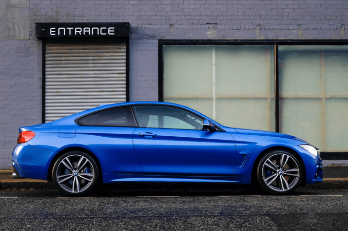 a blue car on the side of the road