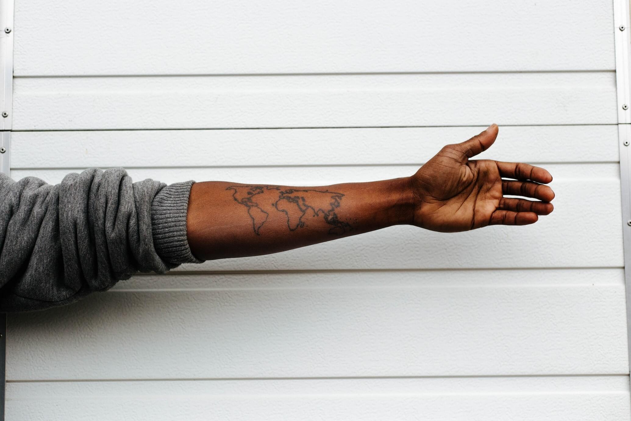 a continent tattoo on man's arm
