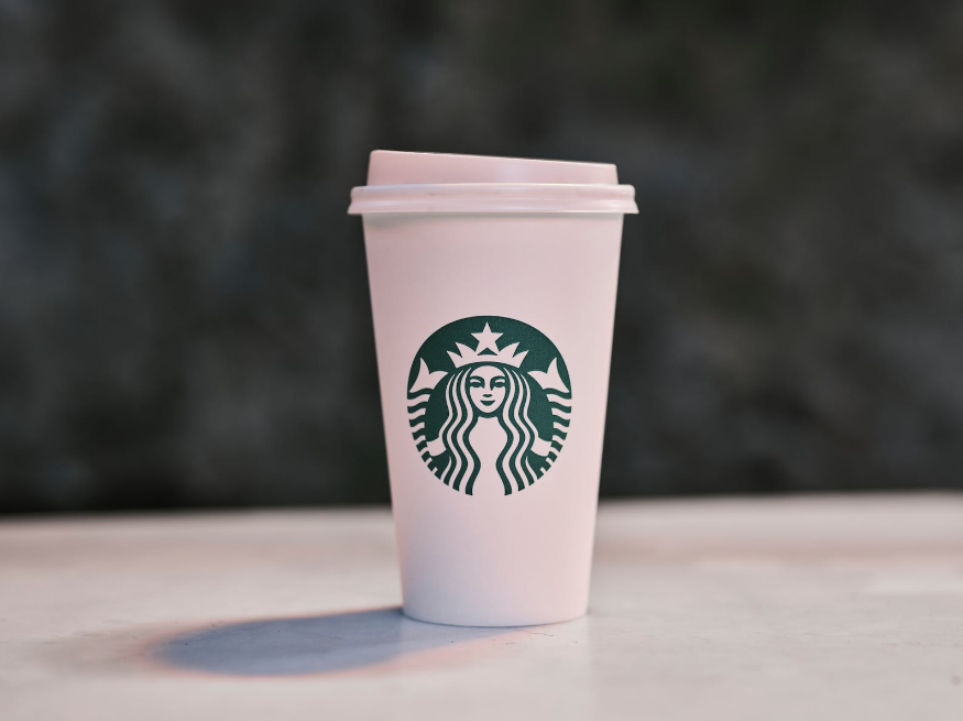 a cup of Starbucks logo on the table