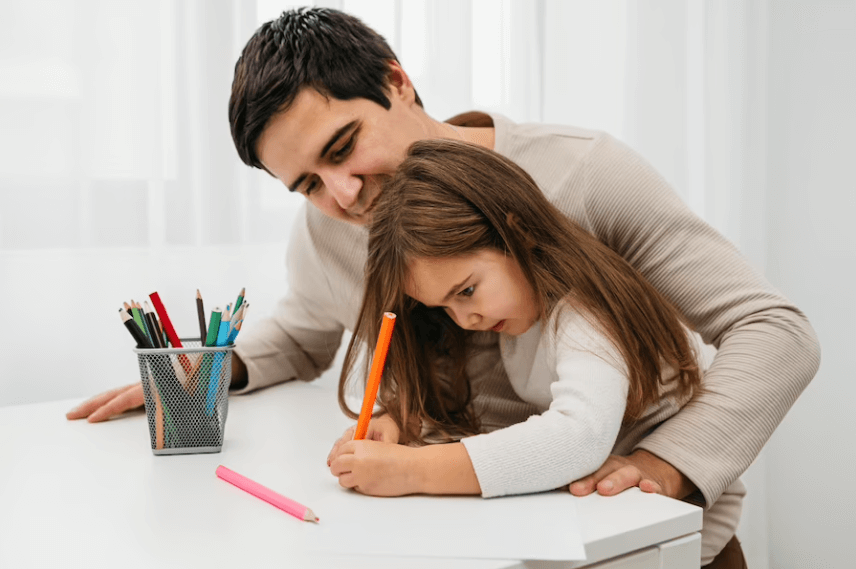 a father teaching his daughter to write