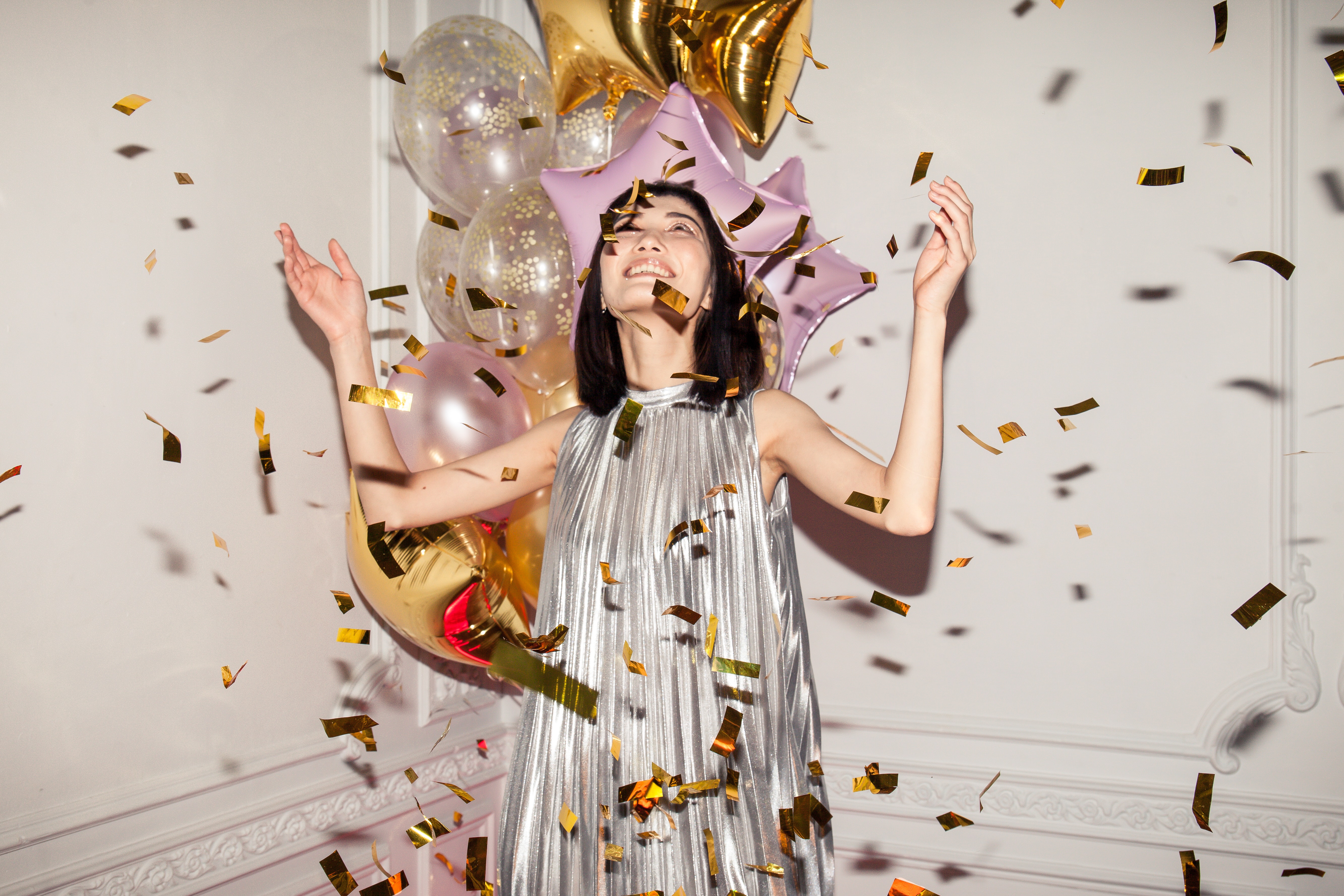 a girl sprating confetti