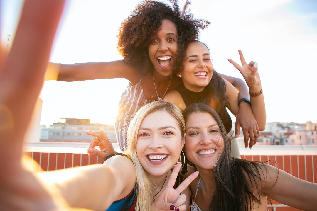 a group selfie of four smiling girls