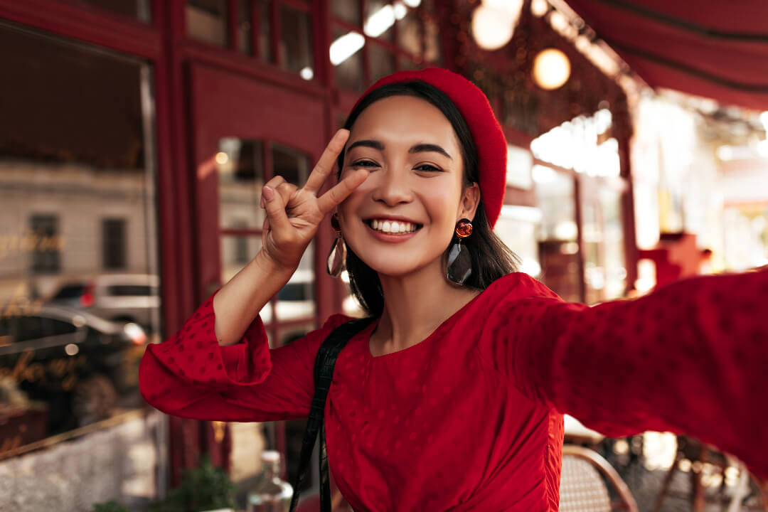 a happy selfie of a girl in red