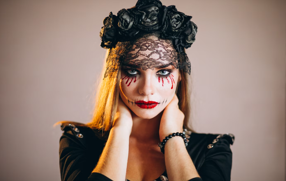 A woman with zombie makeup and black flowers on her head