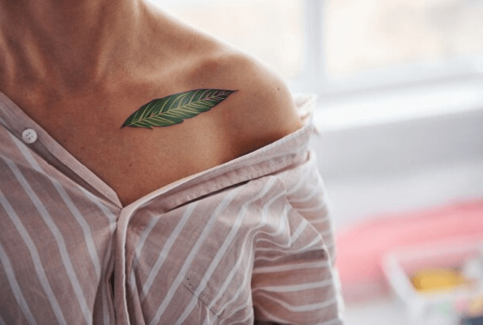 a leaf tattoo on shoulder