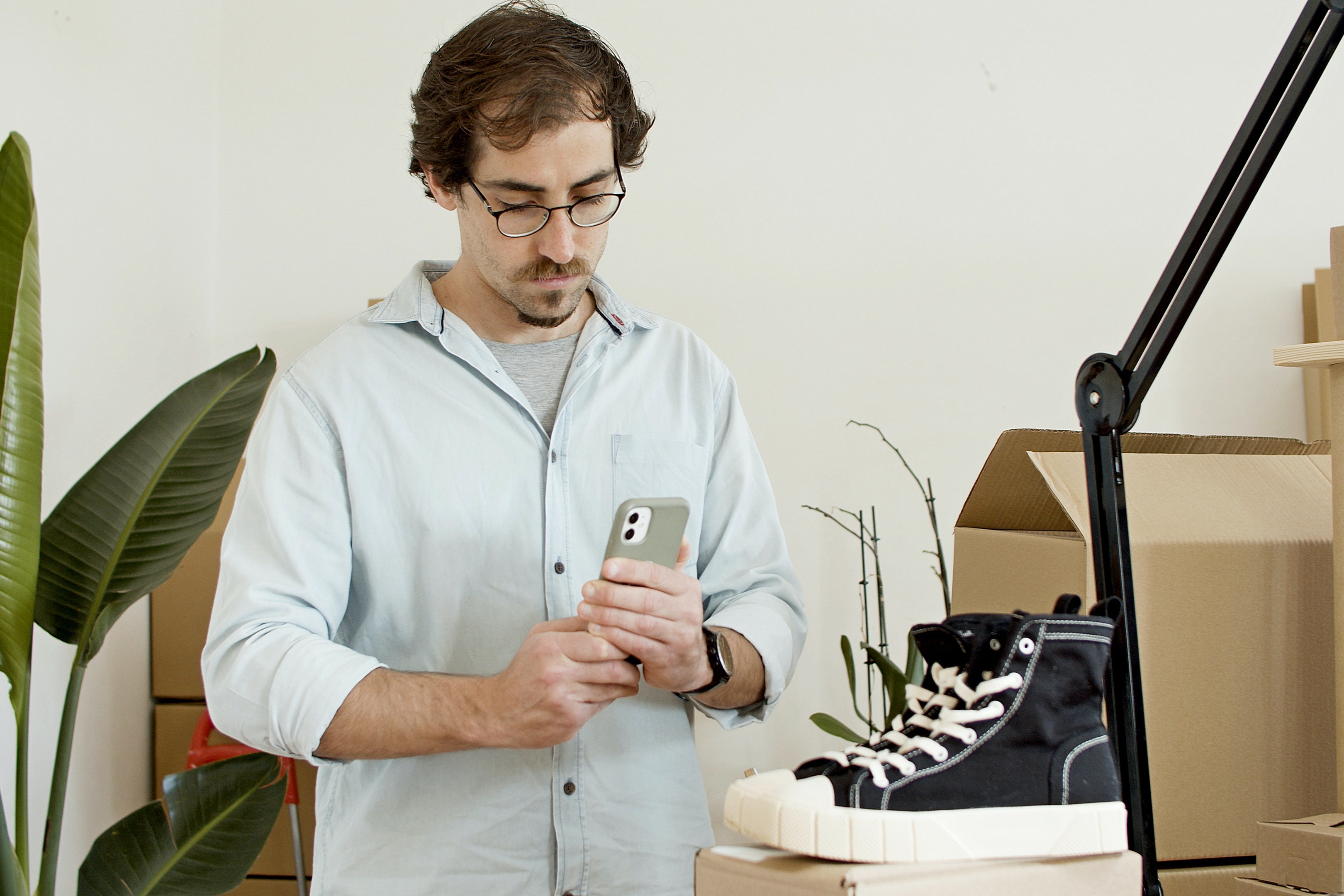 a man is taking photos for his shoes from different angles