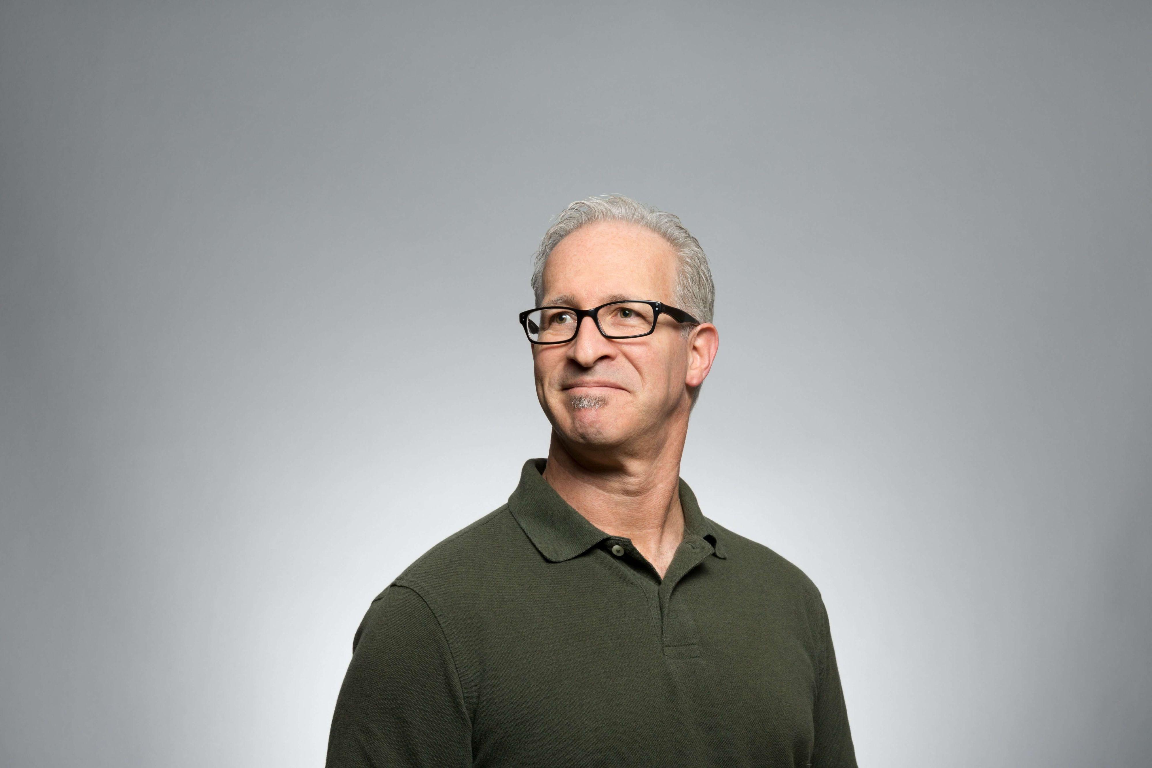 a male portrait with a gray color background