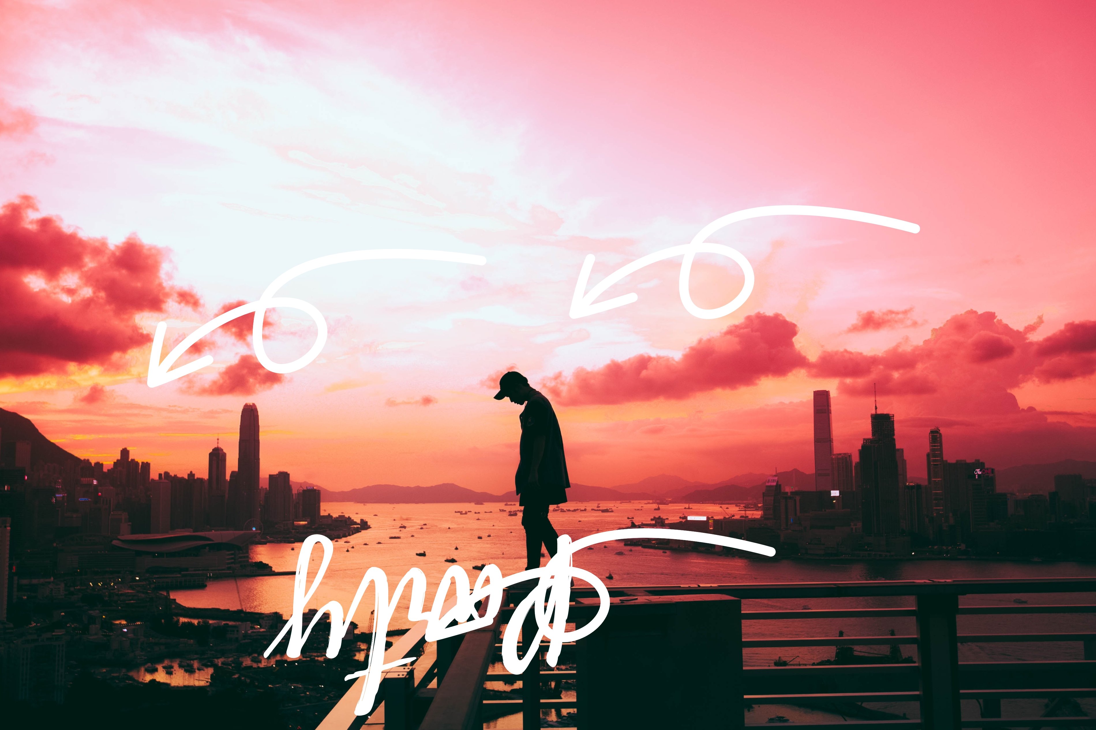 a man standing on a rail with beautiful landscape behind and unwanted scribbles on the cover
