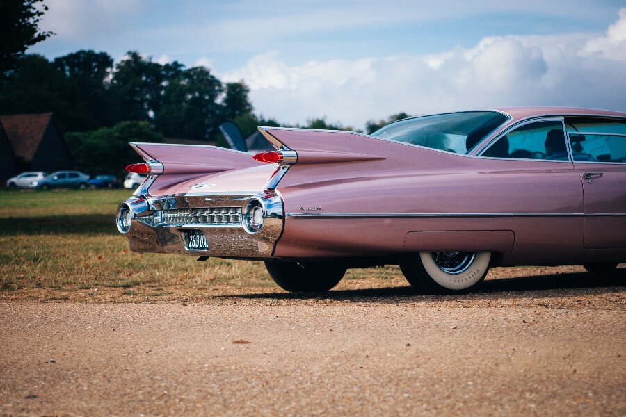 a pink car on the sand road