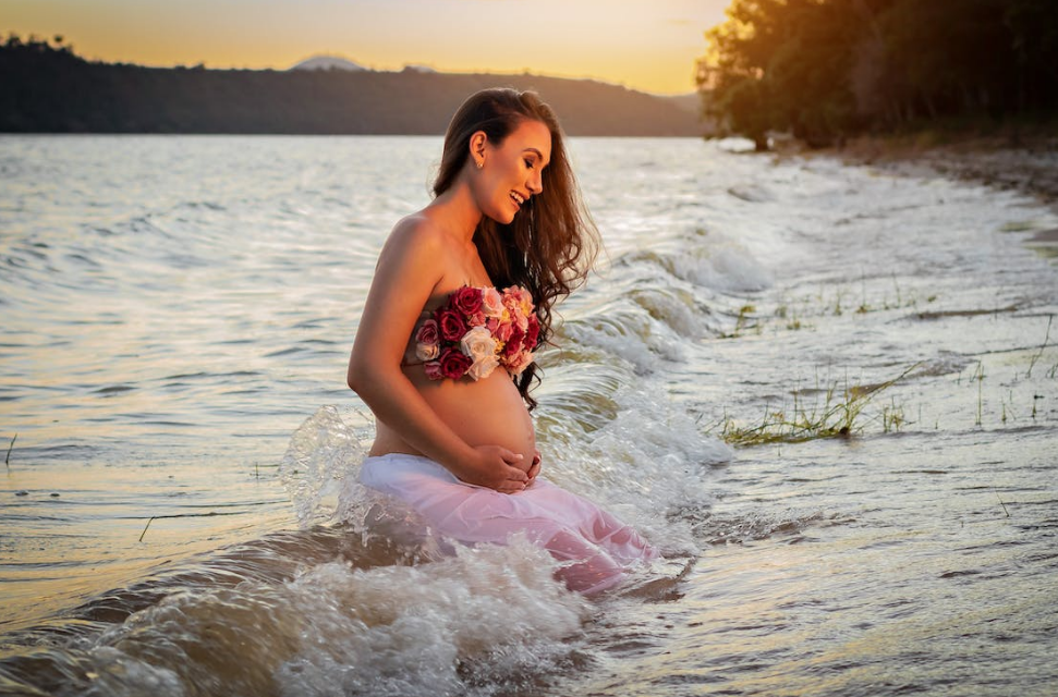 a pregnant woman sitting in the sea