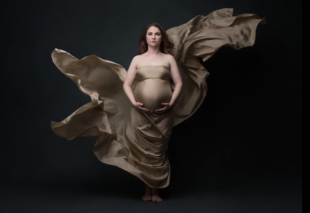 a pregnant woman with dark yellow dress