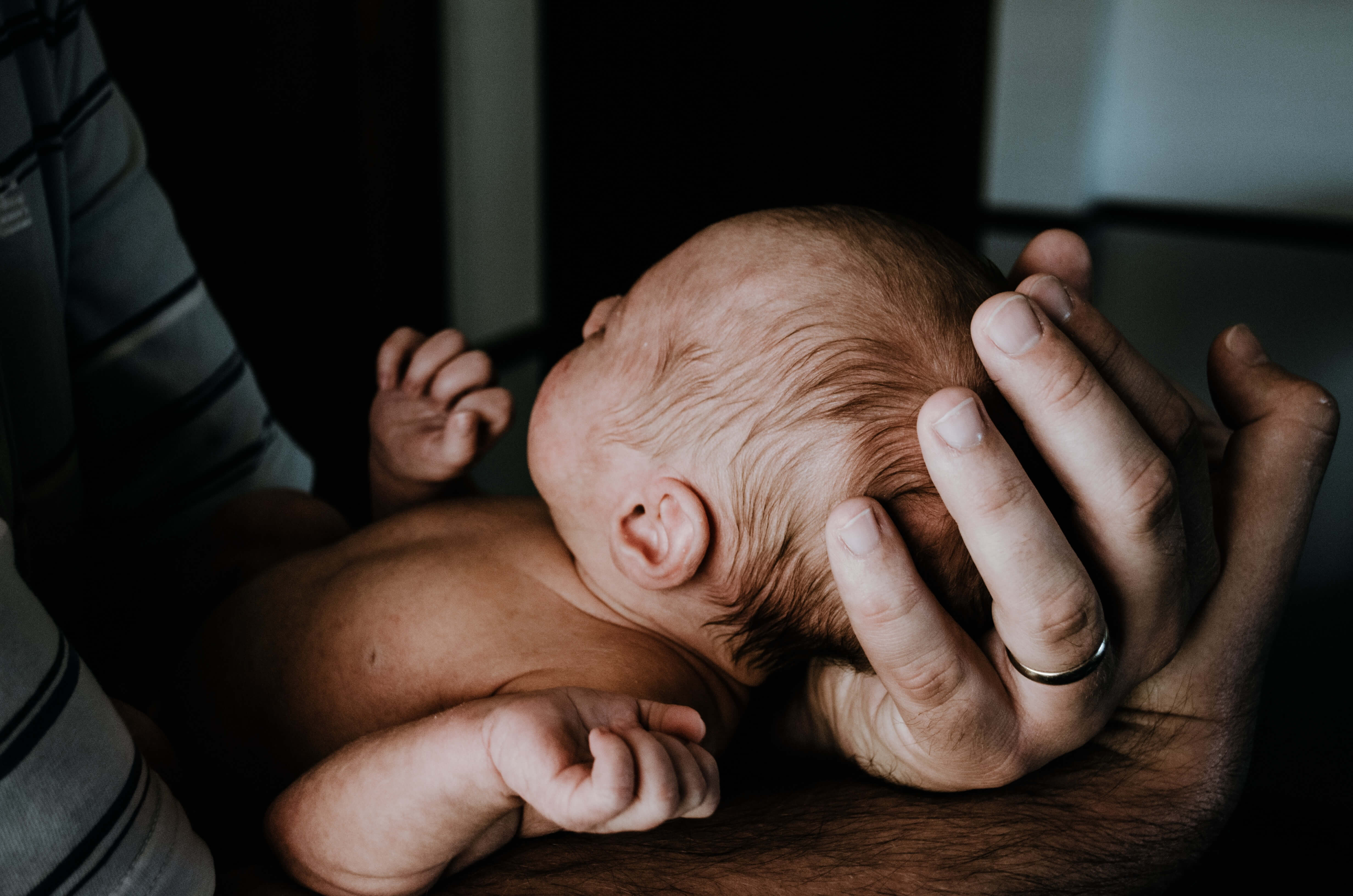 arms around newborn