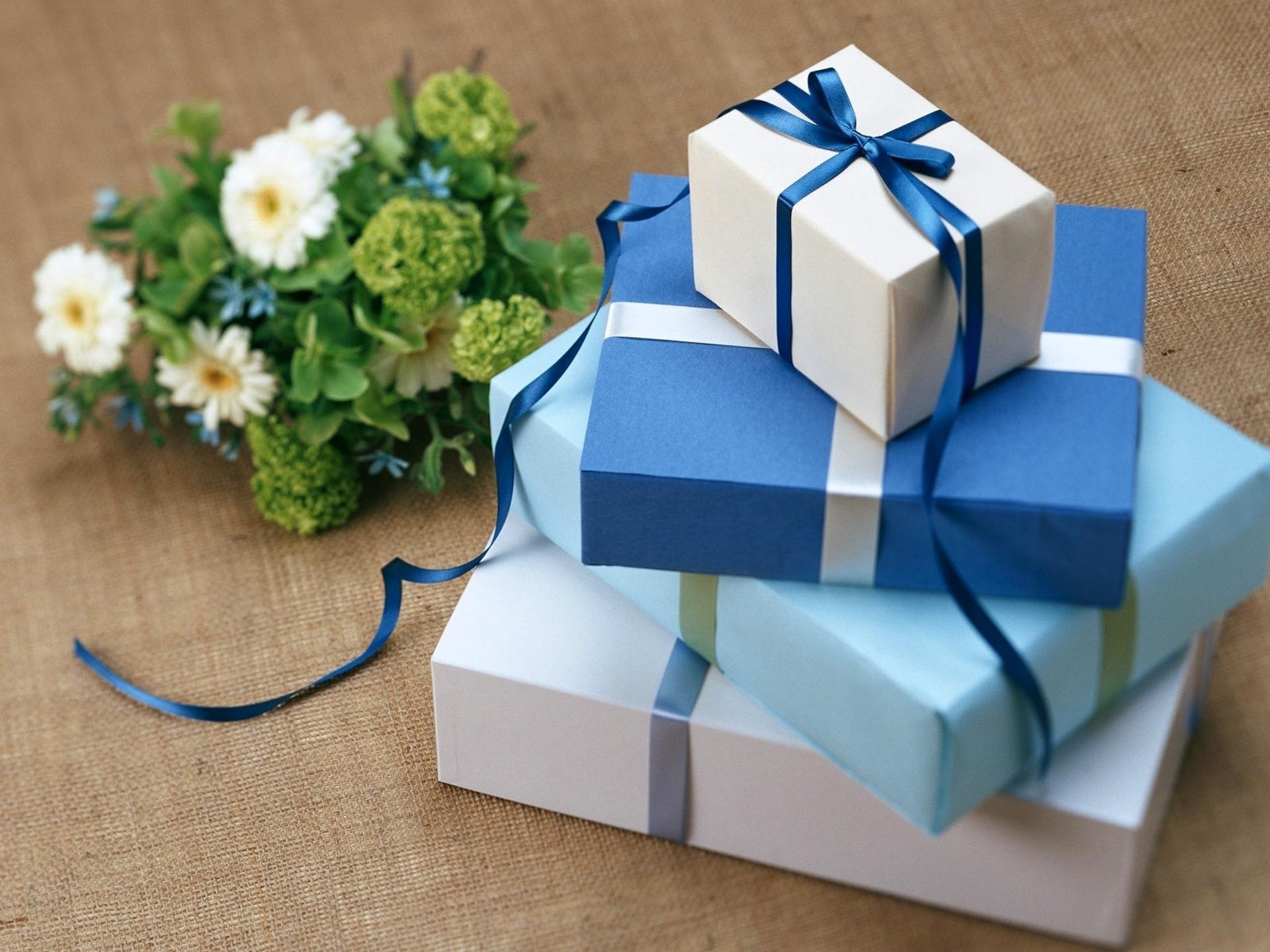 Blue and white gift boxes and a bouquet