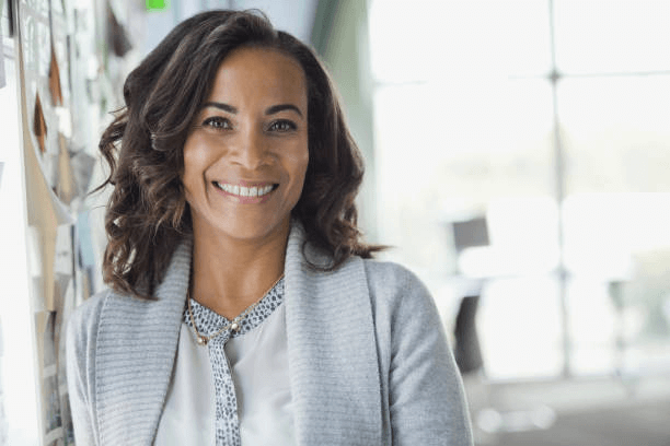 a headshot example of a woman who is wearing a suit and smiling