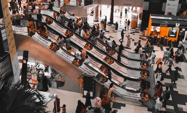 escalators with posters in the mall