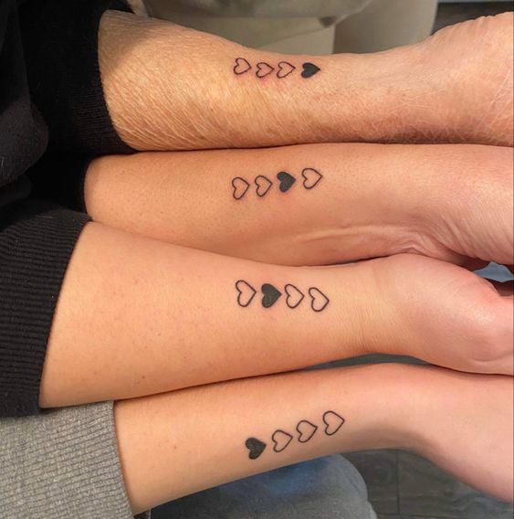 four people with a family heart tattoo
