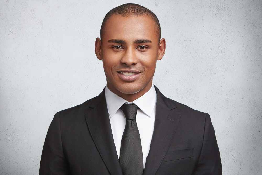 headshot expressive young man wearing formal suit