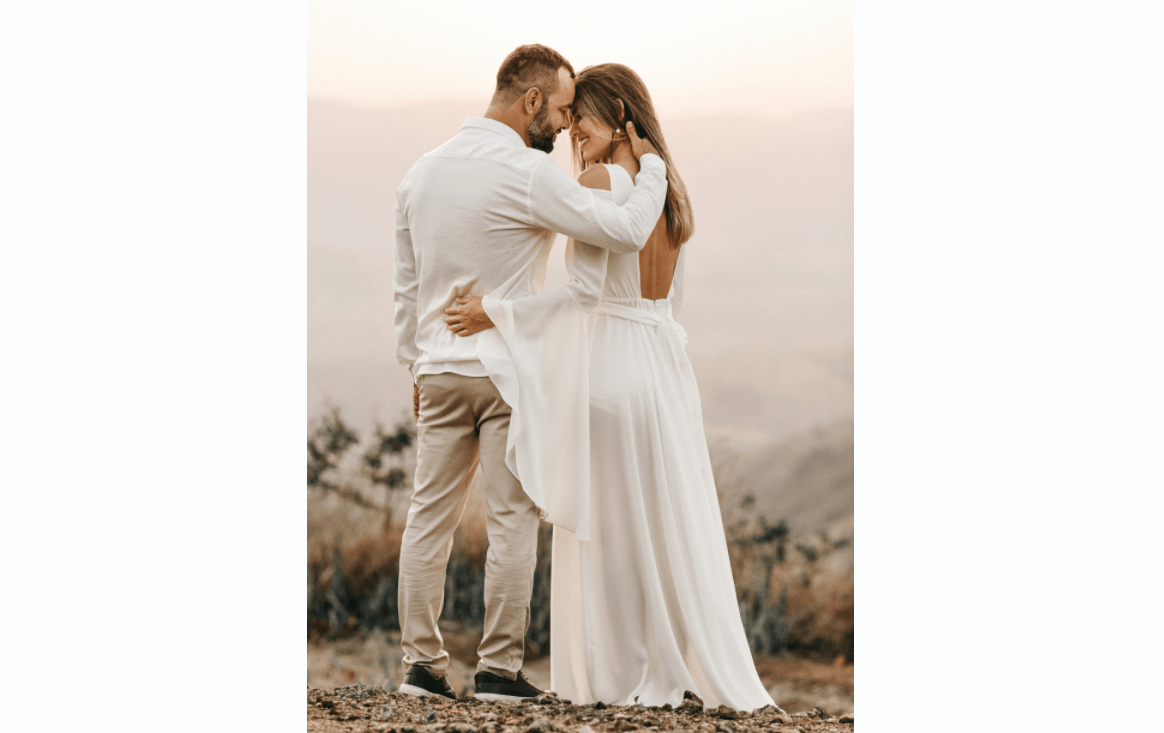 husband and wife close to each other's foreheads on wedding