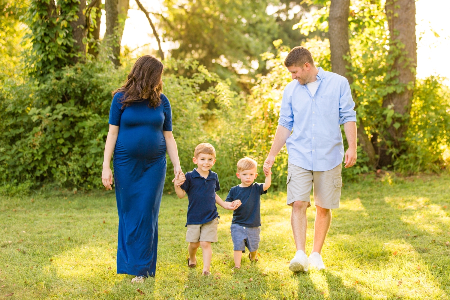 maternity image with family on the grass