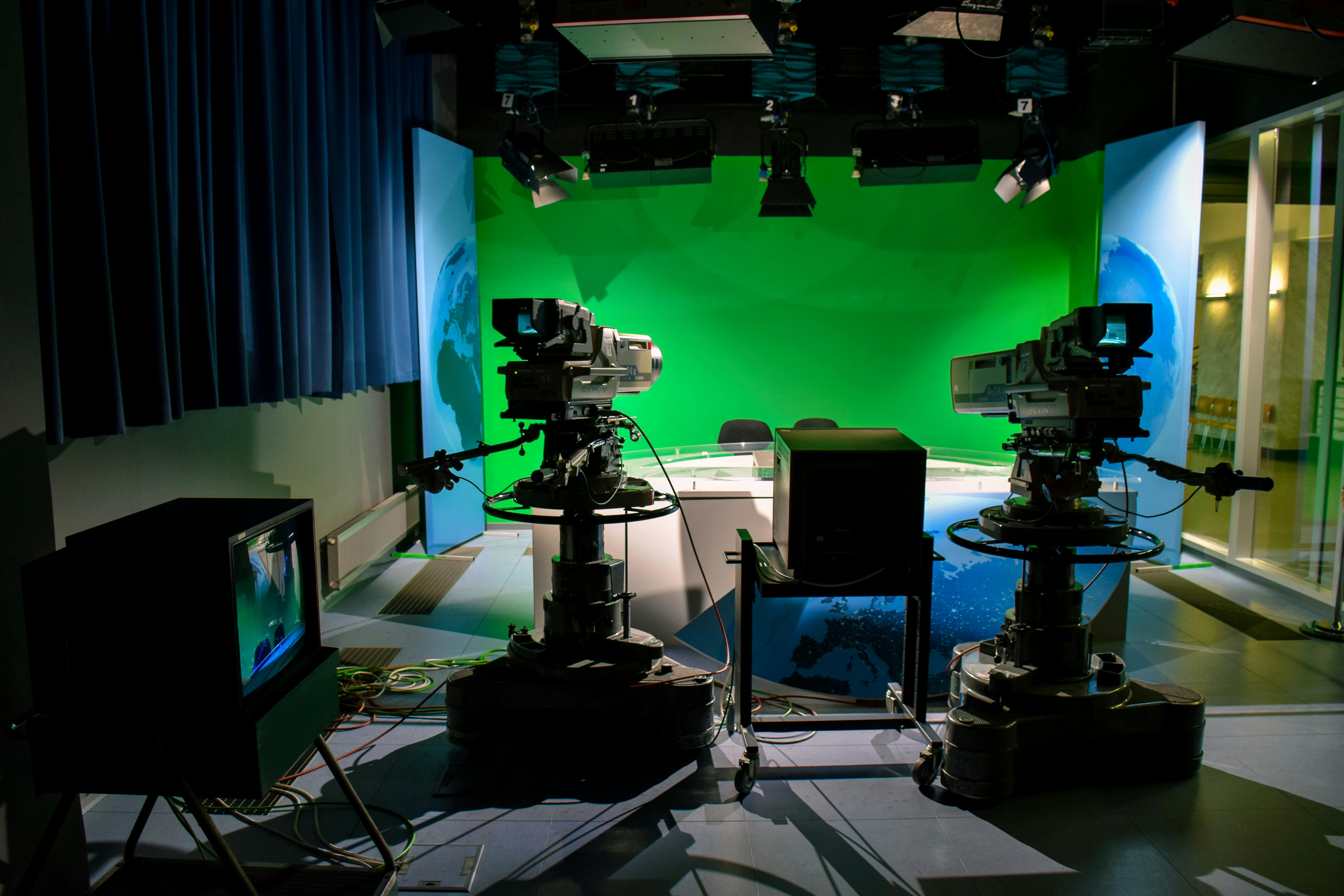 shooting studio with green screen and filming equipment