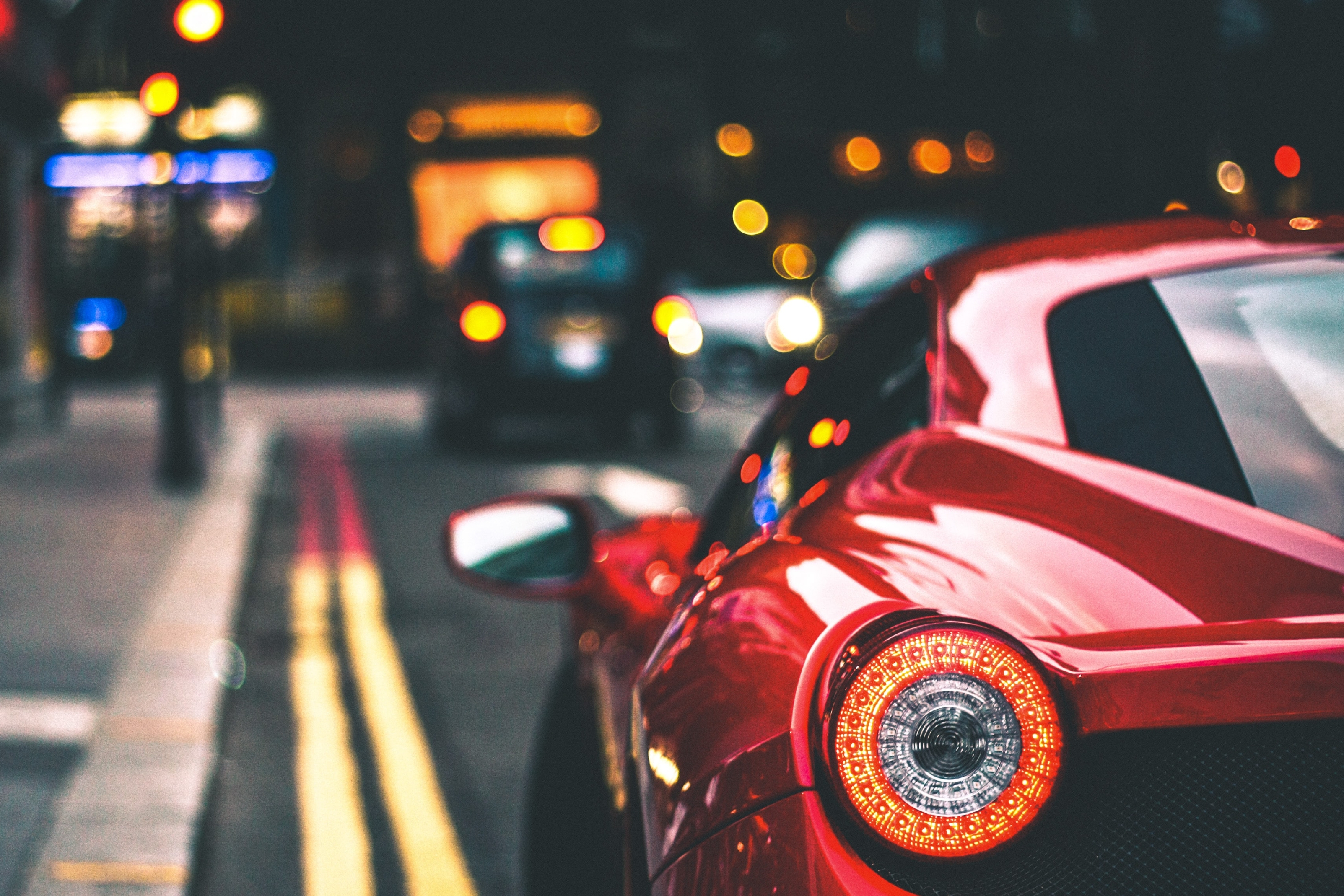 the corner of a red car at the street