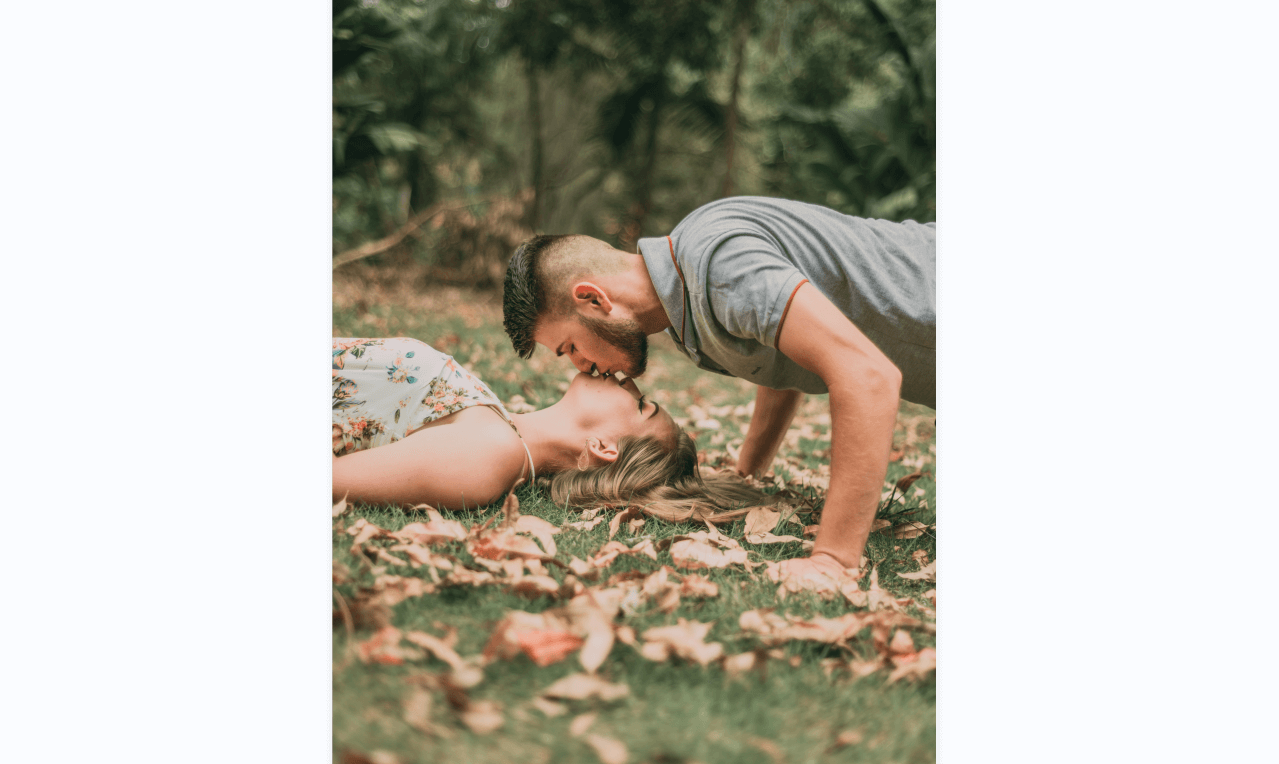 the couple is kissing on the leafy lawn