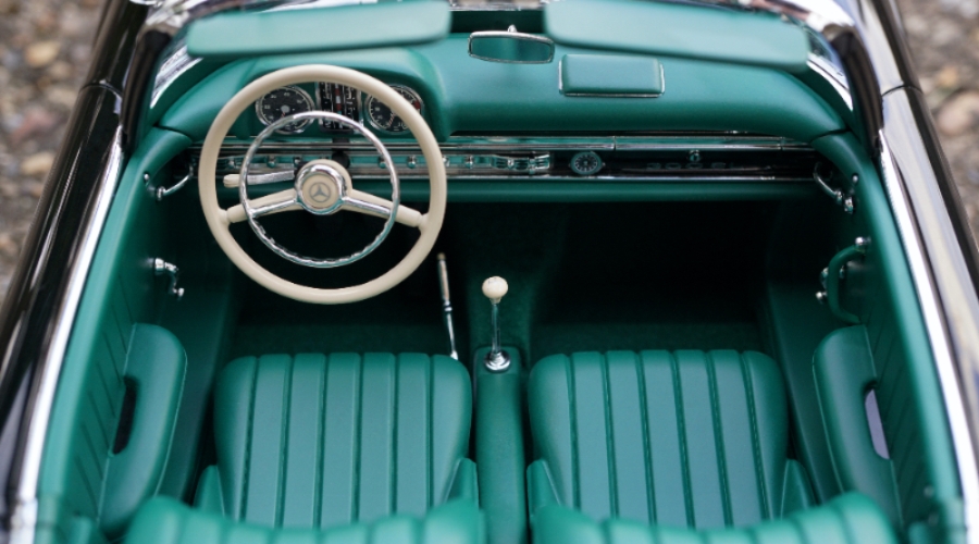 the interiors of a green car with a white wheel