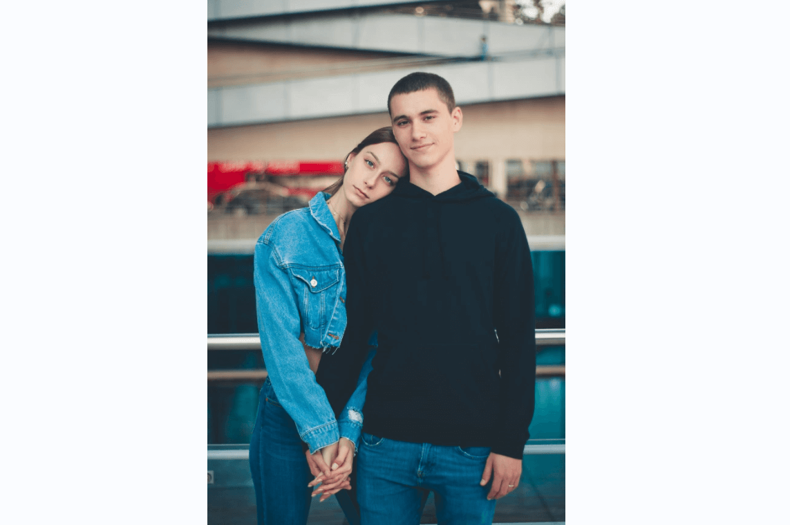 Moments of intimacy. Rear view of young couple embracing while standing  near the waterfall 13524513 Stock Photo at Vecteezy