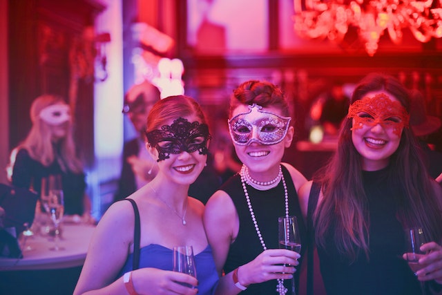 three girls wear mask in the masquerade