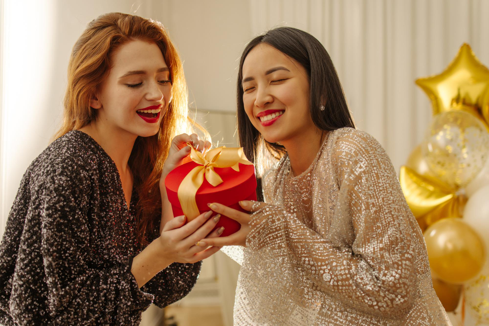 two girls holding a christmas gift