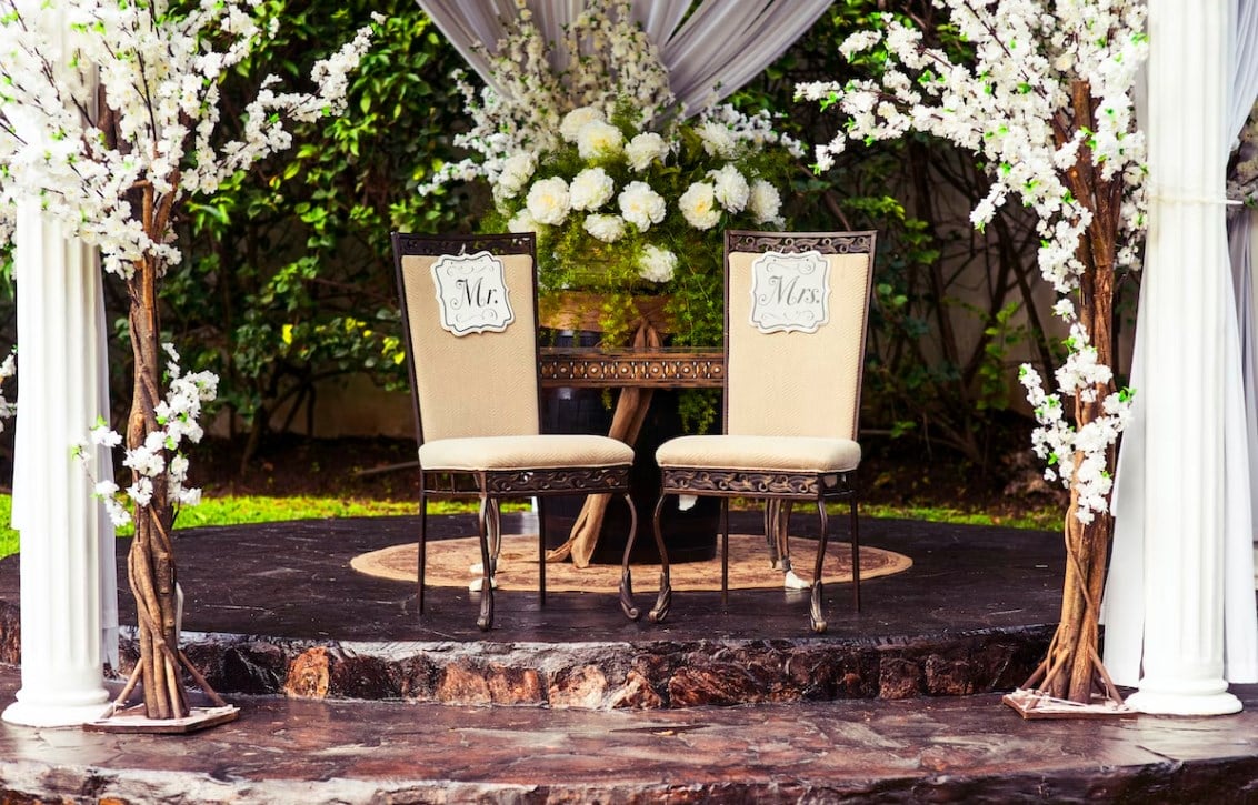 wedding backdrop with chair and flowers