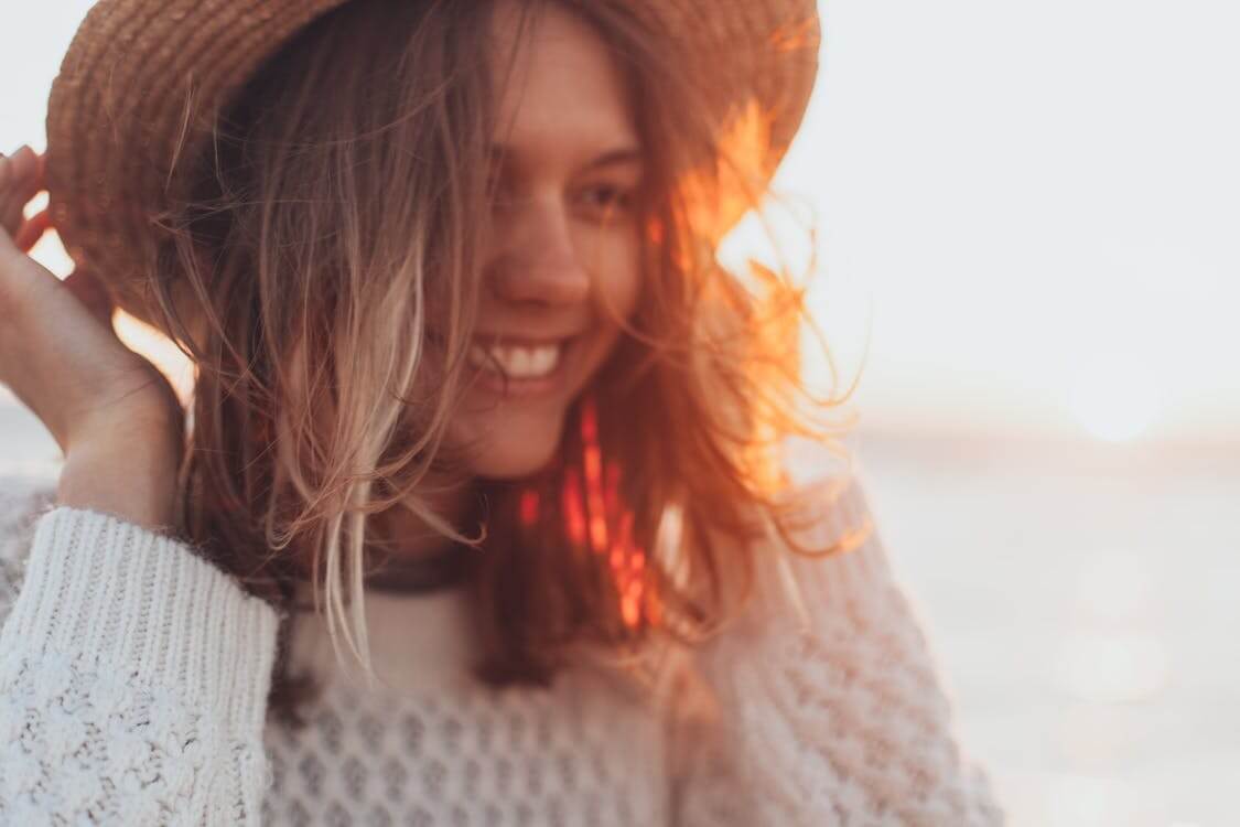 woman smiling under sunlight